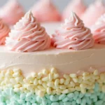 A colorful, fluffy cotton candy cake topped with spun sugar for a whimsical touch.